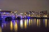 picture of bridge  - Amsterdam by night with the Blue Bridge at the Amstel in the Netherlands - JPG 