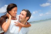 stock photo of beach  - Lovers enjoying sunny day at the beach - JPG 