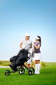 pic of golf  - Young sportive couple playing golf on a golf course - JPG 
