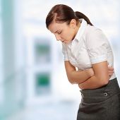 stock photo of woman  - Business woman with stomach issues - JPG 
