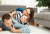 foto of family  - Happy family playing at home - JPG 