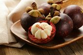 pic of exotic  - fresh exotic fruit mangosteen on a wooden plate - JPG 