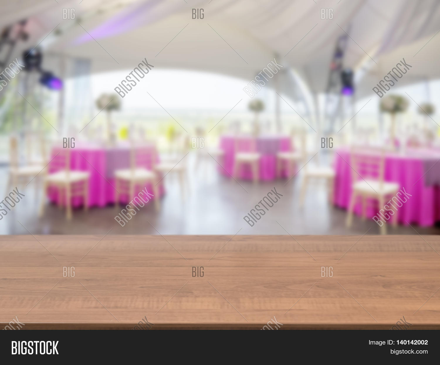 dark wooden empty table in front of blurred restaurant interior dark wooden empty table in front of blurred restaurant interior