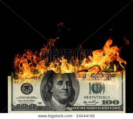Burning dollars close up over black background