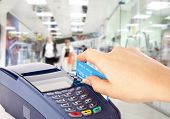 image of payment  - Human hand holding plastic card in payment machine in shop - JPG 