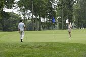 image of golf  - Couple playing golf on golfing course - JPG 