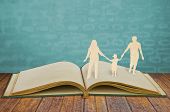 picture of family  - Paper cut family symbol on old book - JPG 