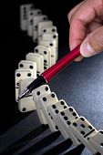 picture of leadership  - Stop the domino effect concept for solution to a problem - JPG 