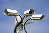stock photo of security  - Security cctv cameras in front of blue sky - JPG 