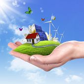 image of earth  - Hands holding a green earth with solar batareis - JPG 