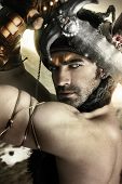picture of security  - Portrait of a sexy male model as ancient warrior with sword and helmet - JPG 