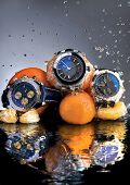 stock photo of watch  - An abstract picture of designer watches and oranges submerged in water - JPG 