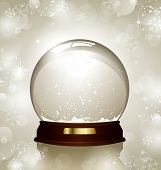 pic of globe  - empty snowglobe against a bright defocused background with glittering lights and snowflakes  - JPG 