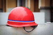 stock photo of lag  - Red hard hat on a wall at a constuction site - JPG 