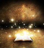 stock photo of opening  - Open bible glowing with cross on the background - JPG 