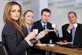 stock photo of meeting  - Business team having a coffee break during their meeting - JPG 