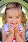 pic of toddlers  - Cute girl poses in tunnel at the playground - JPG 