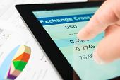 pic of currency  - Hand on screen tablet pc with currency exchange information - JPG 