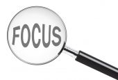 picture of curiosity  - Focus concept with text under a magnifying glass - JPG 
