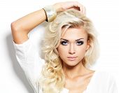 stock photo of beauty  - Beautiful blond woman with long curly hair and style makeup - JPG 