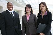 stock photo of business people  - An attractive team of diverse business people smiling at company - JPG 
