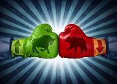 picture of investment  - Stock market trading business concept with two boxing gloves with arrows going up and down with bull and bear icon emblems stitched to the glove as investment decisions and financial success with radial background - JPG 