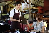 pic of restaurant  - waiter giving menu to female costumer at the restaurant - JPG 