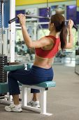pic of pulldown  - A woman works out at a back station in a heath and fitness center - JPG 