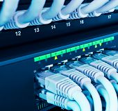 image of cord  - closeup of network hub and cables blue toned - JPG 