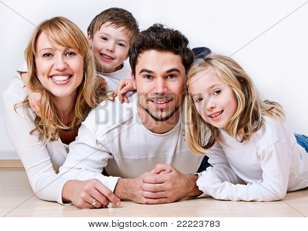 Picture or Photo of Sweet young family having fun on the floor in their home