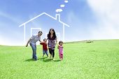 pic of family  - Happy family running on field with a drawn house in background - JPG 