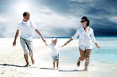 stock photo of family  - View of happy young family having fun on the beach - JPG 