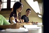 image of study  - Happy student studying and writing portrait of hispanic young man doing homework in college library and smiling at camera - JPG 