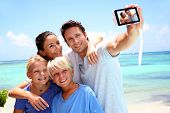 stock photo of family  - Couple and children taking family picture - JPG 