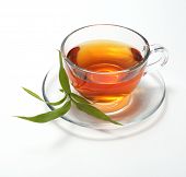 stock photo of cup  - cup with tea and green leaf - JPG 