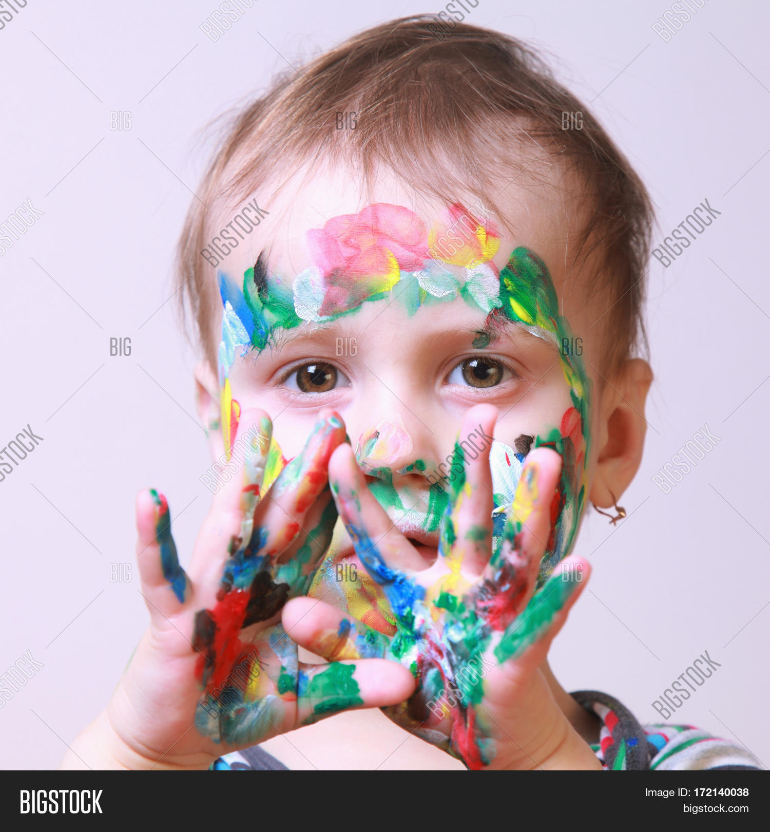 beautiful little baby girl doing make up (humorous picture) Stock Photo