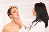 image of medical doctors  - Pretty doctor examining beautiful young female - JPG 