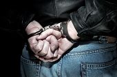 foto of transportation  - A man is arrested and handcuffed before being transported to jail - JPG 