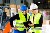 pic of points  - Worker or warehouseman and his coworker with clipboard at warehouse of freight forwarding company - JPG 