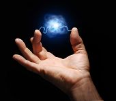 picture of discharge  - male hand with electricity arcing between thumb and middle finger with plasma ball suspended in the center - JPG 