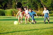 stock photo of preschool  - Four preschool kids playing with the ball - JPG 
