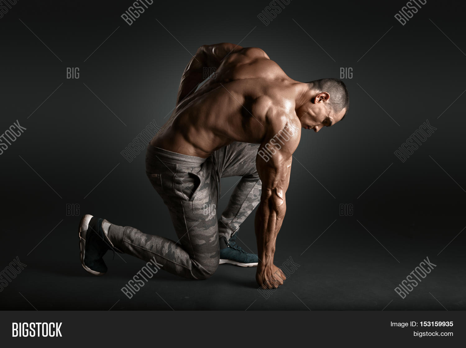 Bodybuilder showing his back and biceps muscles, personal fitness