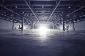 picture of interior  - Modern empty dark storehouse with light at the end - JPG 