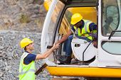 image of construction  - happy construction manager handshaking with bulldozer operator at construction site - JPG 
