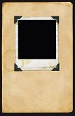 foto of  photo  - Instant photo Instant Picture aged with photo corners on aged page of paper - JPG 