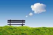picture of blue sky  - bench on green grass with conceptual text - JPG 