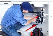 picture of industrial  - Mature plumber fixing a sink at kitchen - JPG 