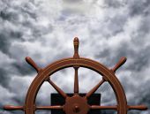 stock photo of steady  - Illustration of a ships wheel steering a steady course through rough waters - JPG 