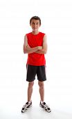 pic of sports  - A young boy teenager wearing sports wear clothing tank top shorts and sports shoes and standing with arms crossed - JPG 