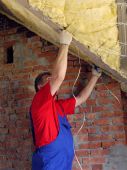 image of construction worker  - Construction worker thermally insulating house attic with rockwool - JPG 